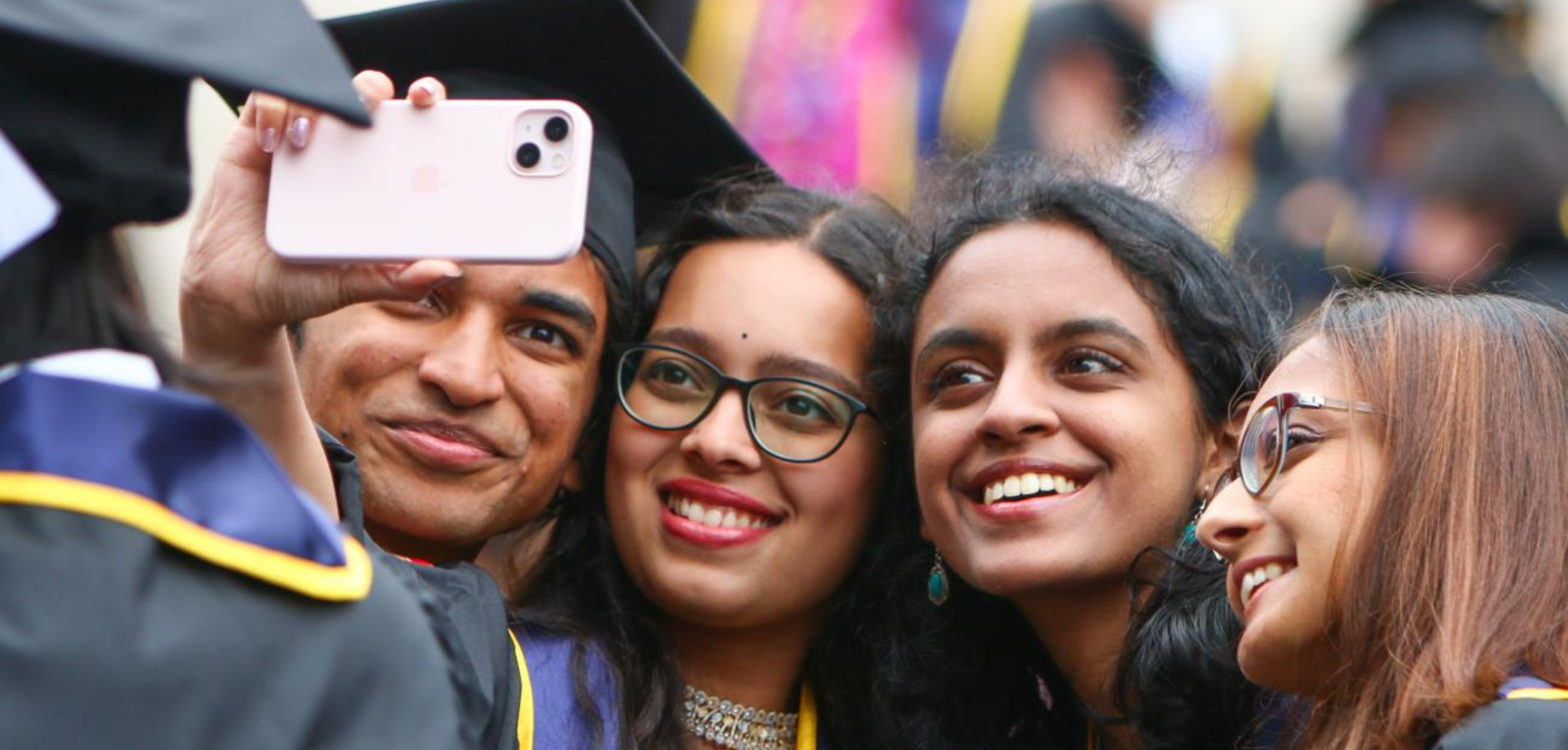 Students taking a selfie at graduation