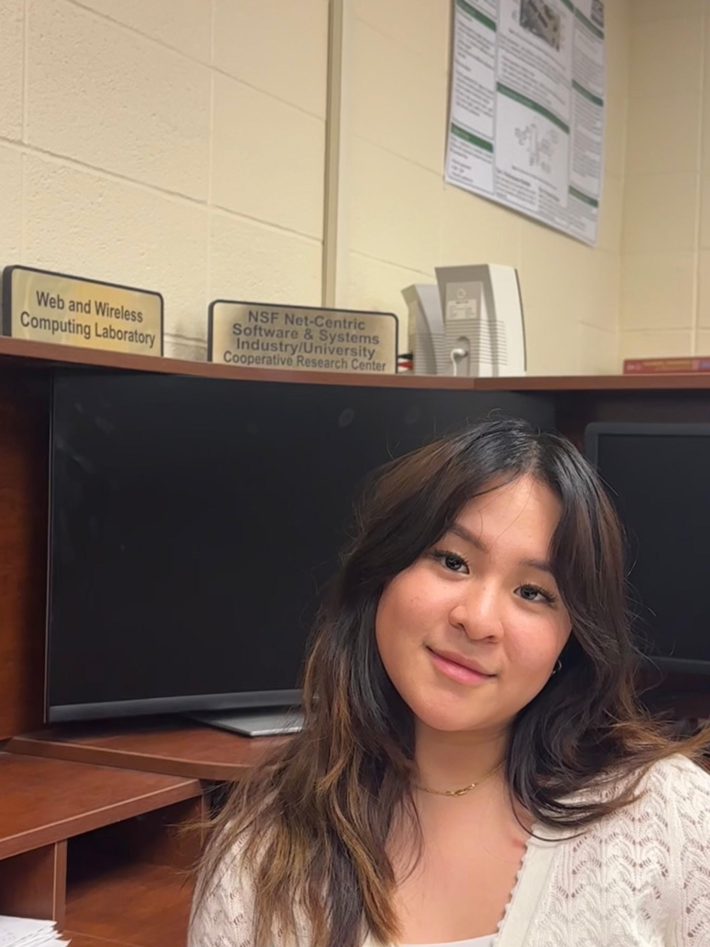 Megan DSPA in front of computer monitors in an office setting.