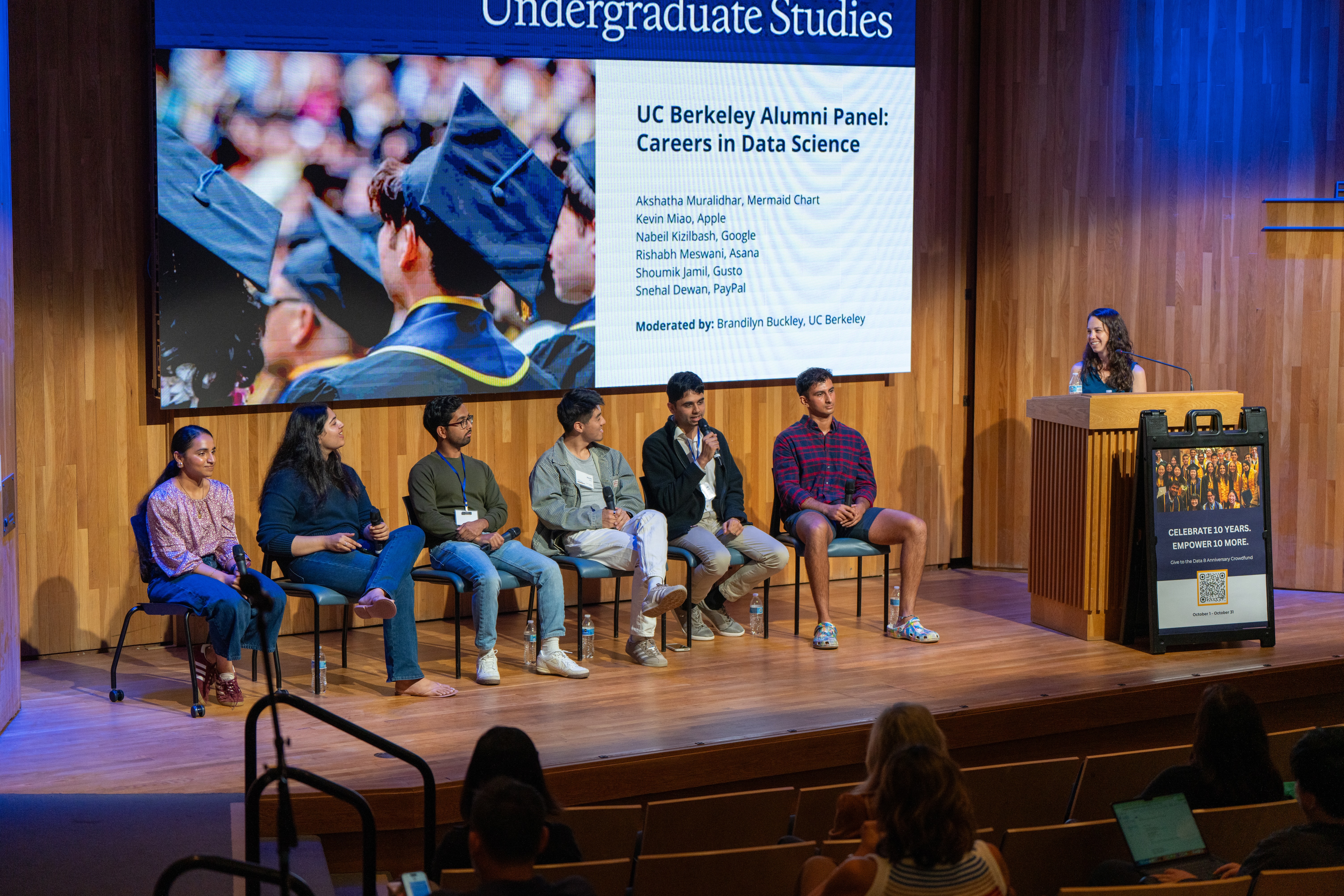 2025 Homecoming panelists listen while alum Rishabh Meswani speaks into the mic