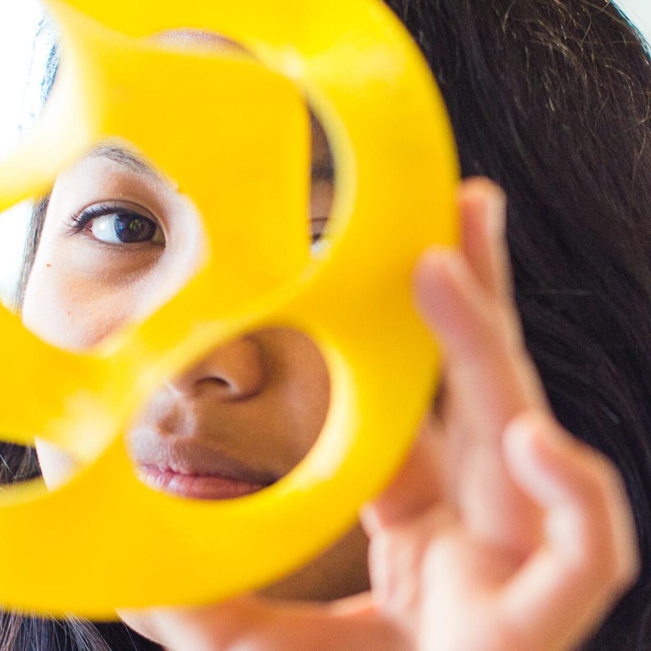 person peering through geometric material