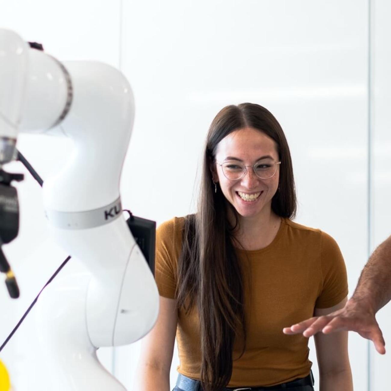 people working with robot arm