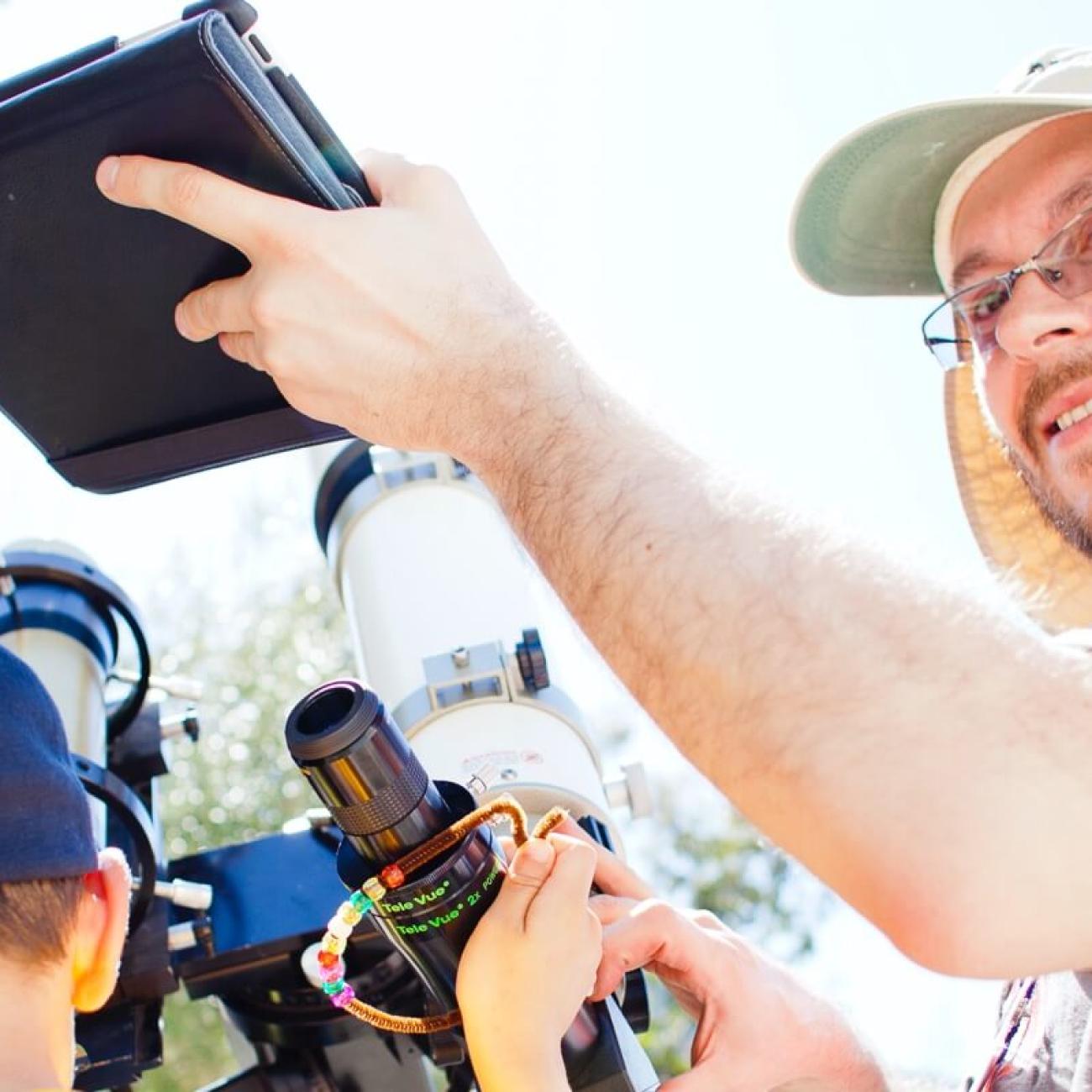 people with cameras, computers and a telescope