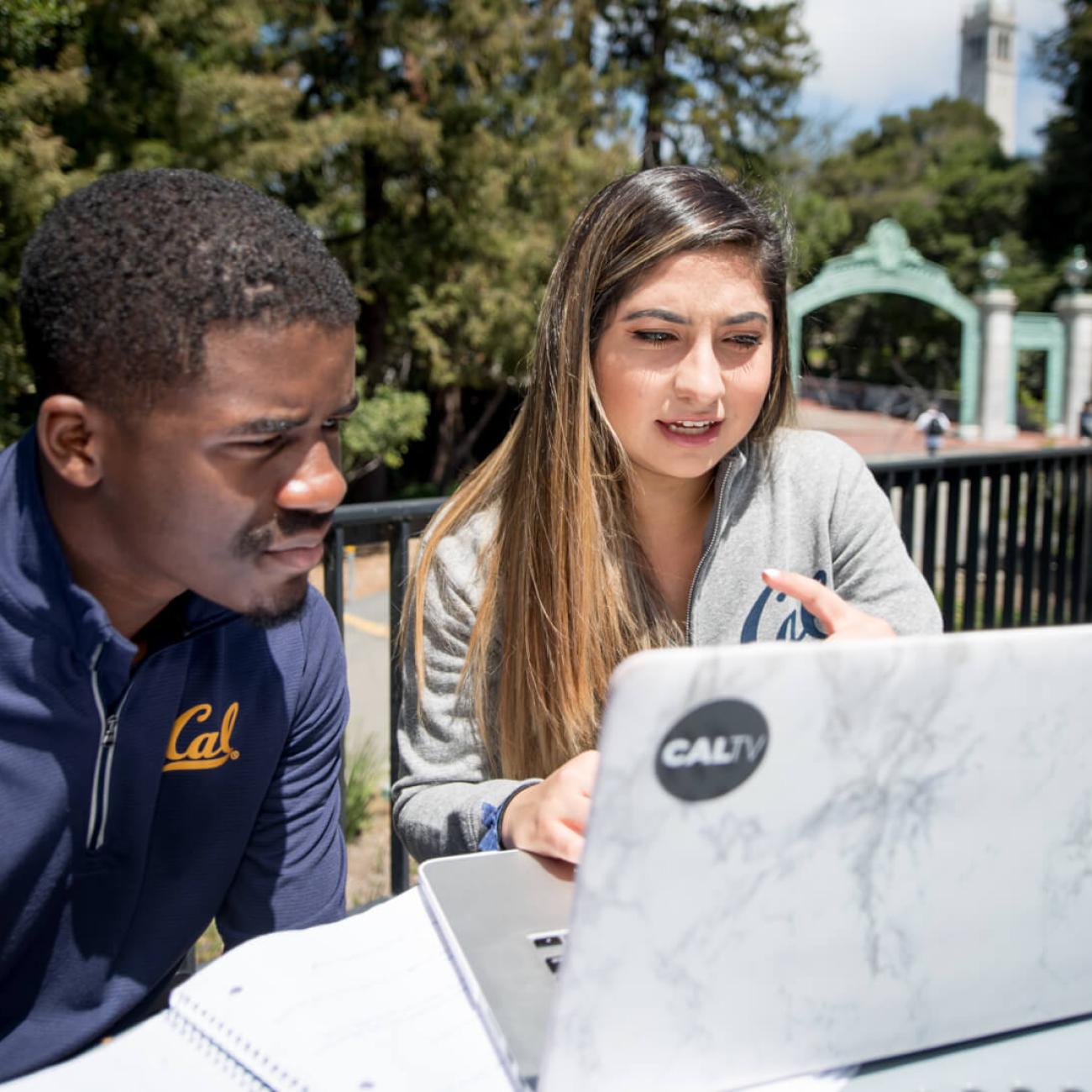 Pair of people looking at a computer screen