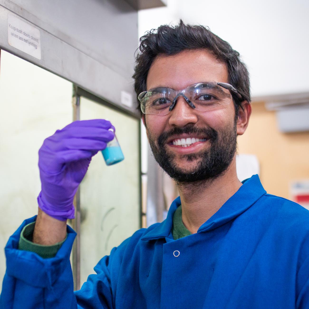 A UC Berkeley scholar smiles while working at the Yaghi Lab in Berkeley, Calif. (Photo / Kayla Sim / UC Berkeley College of Computing, Data Science, and Society)