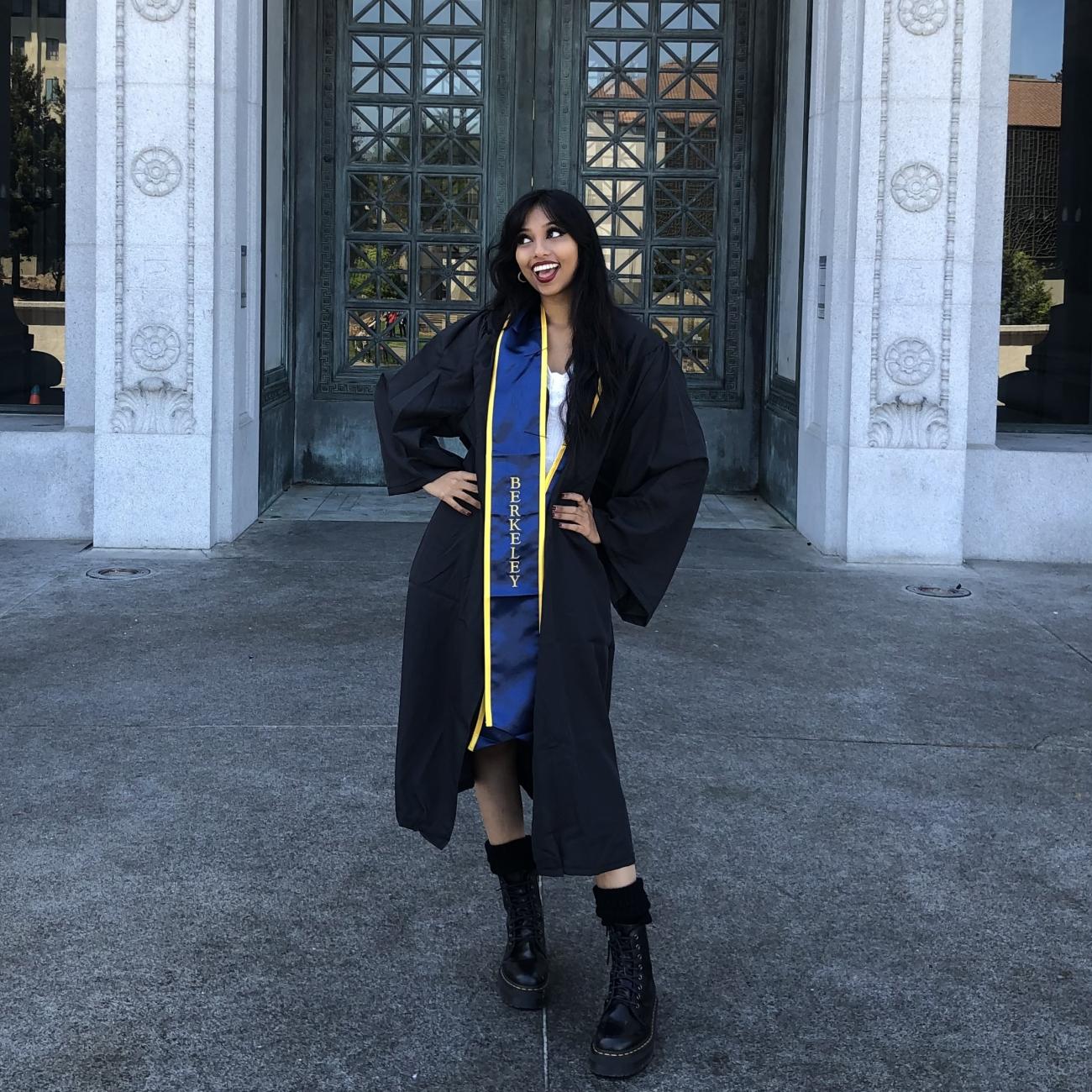 Rashmi Bhoj, B.A. '21, poses for graduation photo in front of Hearst Mining Building