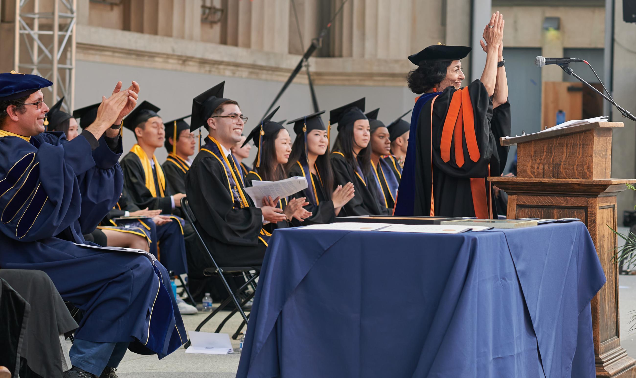John DeNero (left), associate dean for undergraduate studies at CDSS, and Jennifer Chayes (right), associate provost for CDSS, applaud the graduates. (Photo/ KLCfotos)