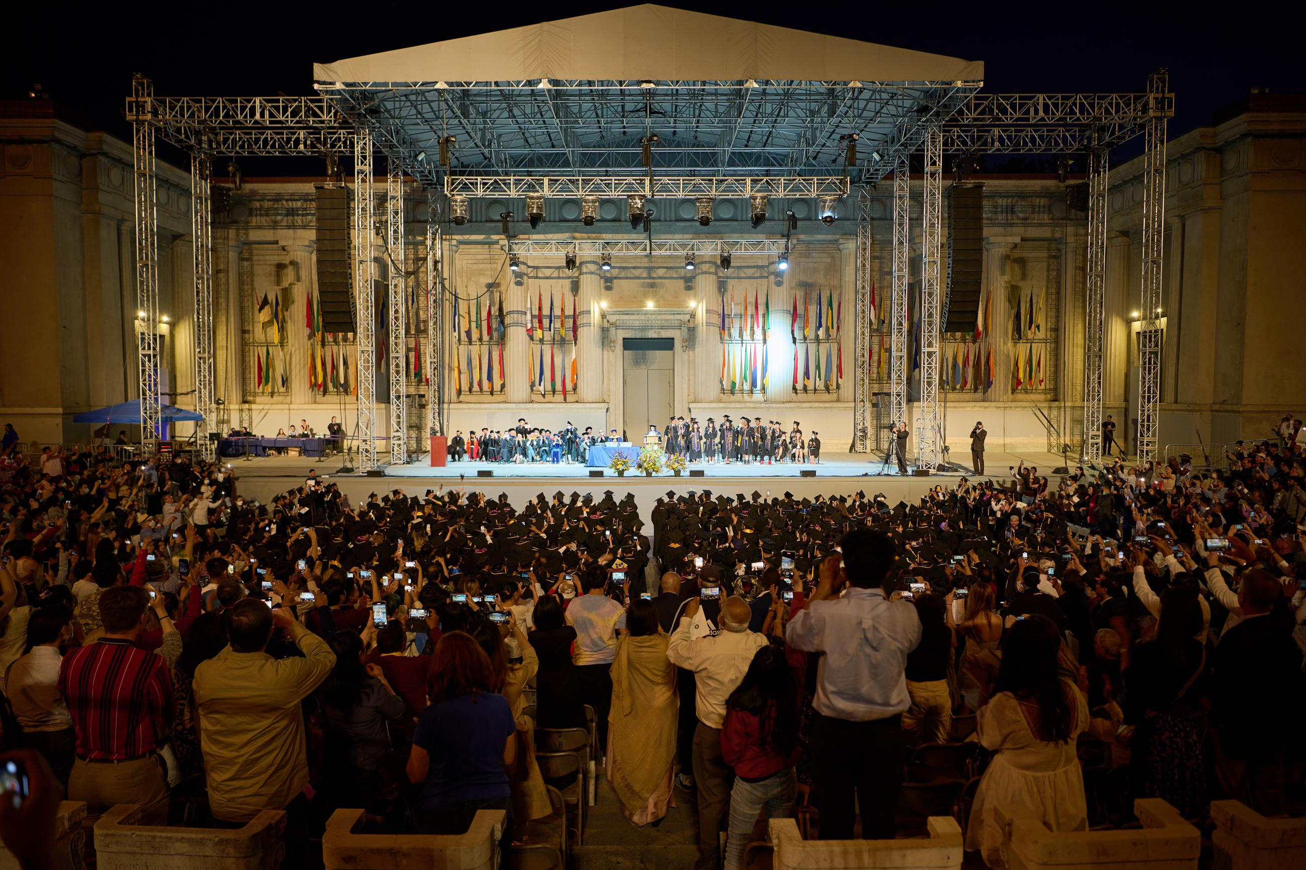 Guests in the Heart Greek Theater prepare to take photos when the graduates names are announced. (Photo/ KLCfotos)