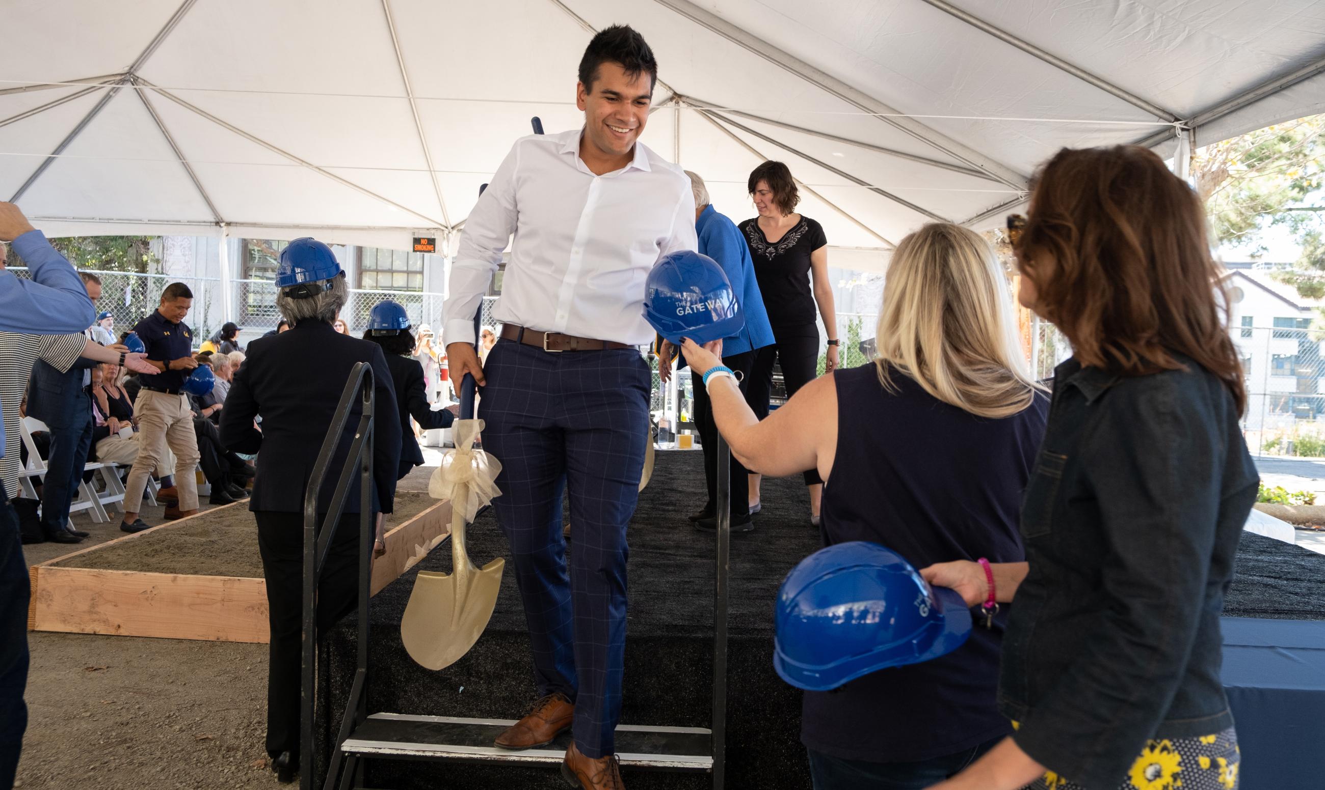 Undergraduate Nitesh Nagpal receives a hard hat for the ceremonial groundbreaking. (Photo/ Julian Meyn/Berkeley Computing, Data Science, and Society)