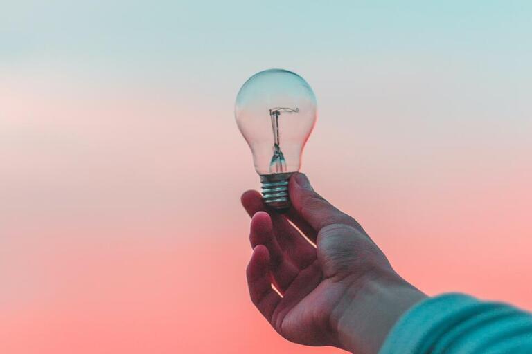 hand holding lightbulb
