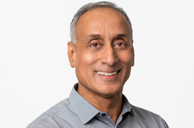 Portrait of Prabhakar Raghavan smiling against a white background 