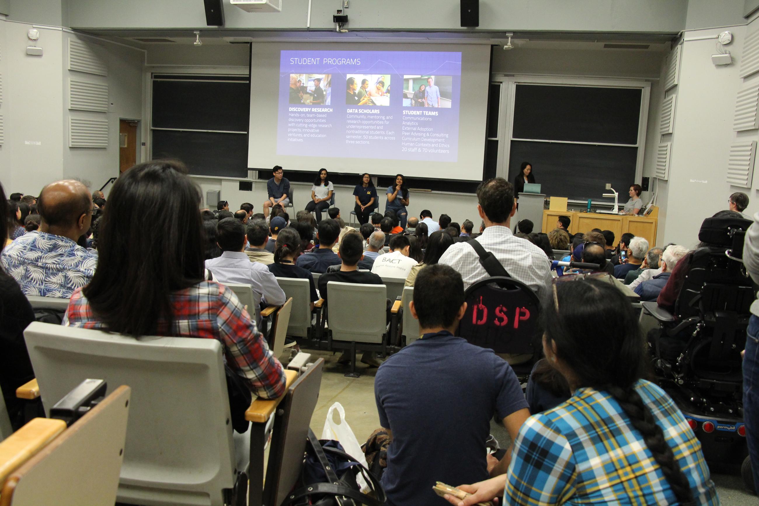 The audience in a crowded lecture hall listens attentively to a Data Science panel at CalDay