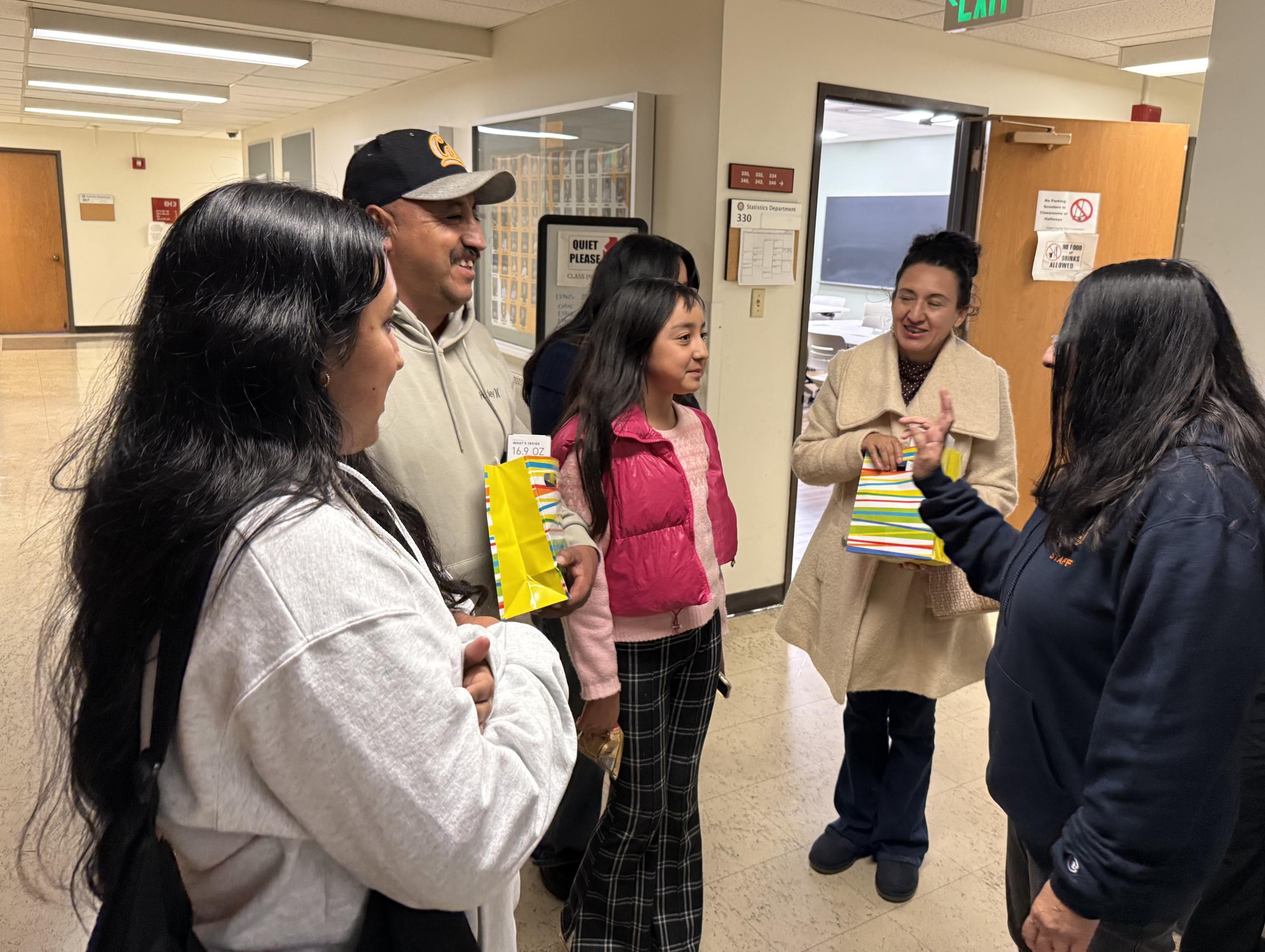 Professor Ani Adhikari surprises Gonzalez Perez by greeting parents with gratitude and praise for their daughter.