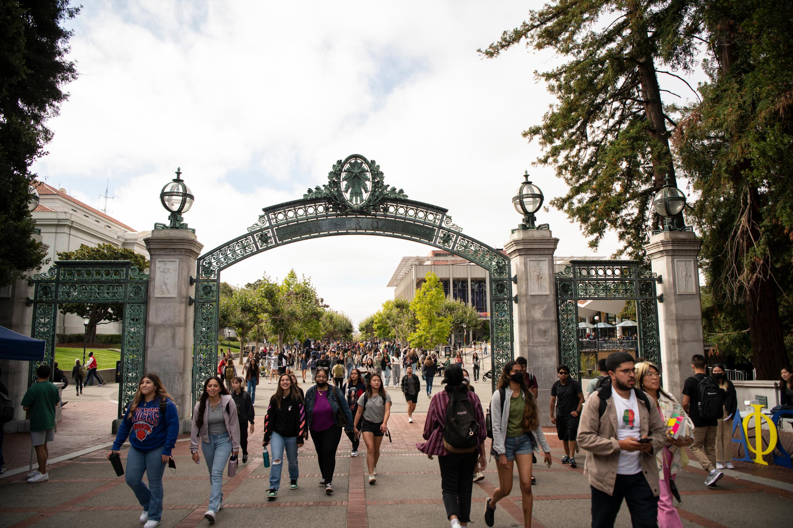 Crowd of students walking through Sather Gate