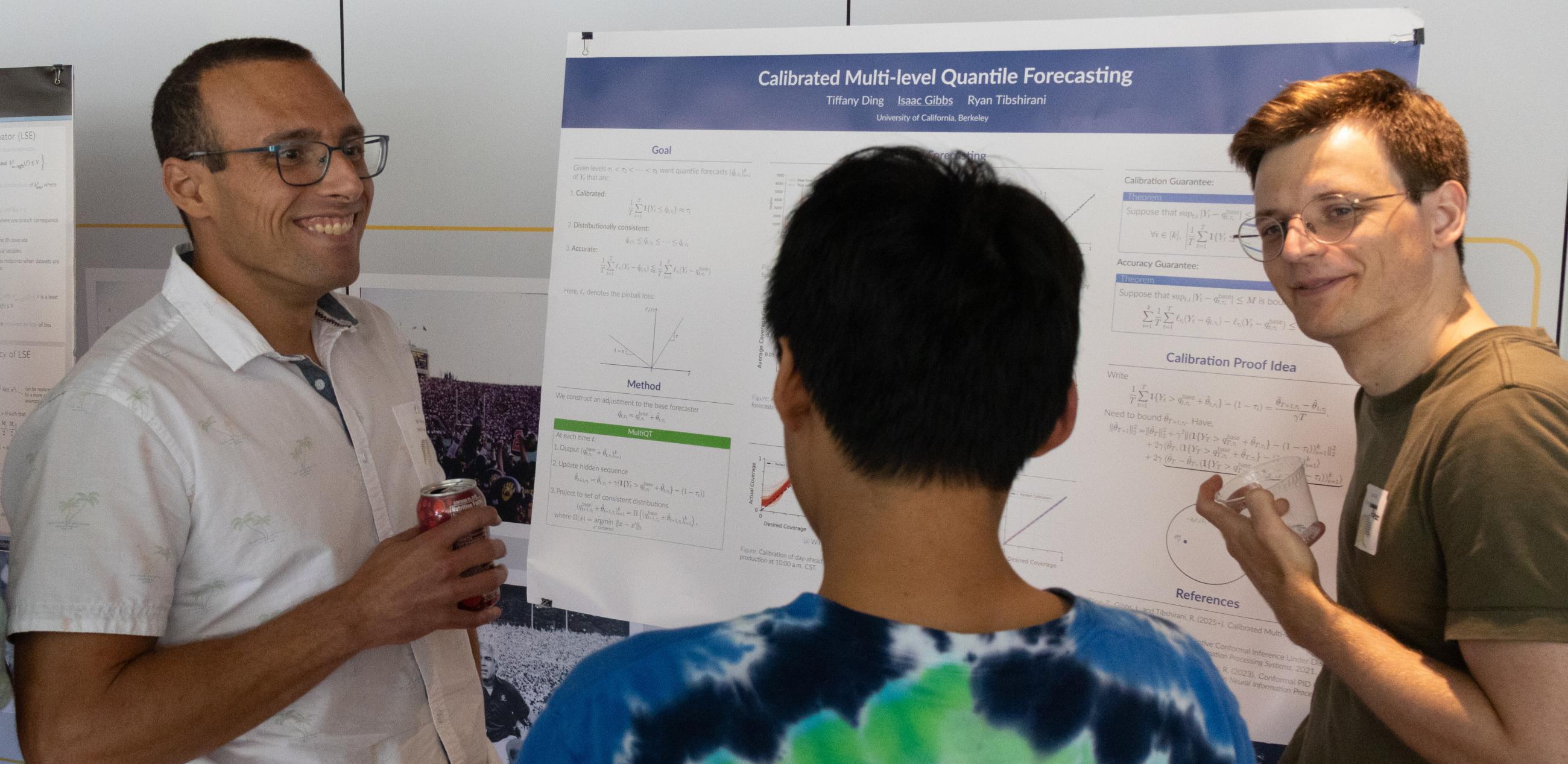 Ryan Tibshirani (left) discusses research with students at a poster session