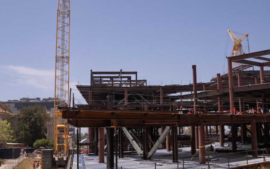 Construction workers placing the final steel beam onto the Gateway building