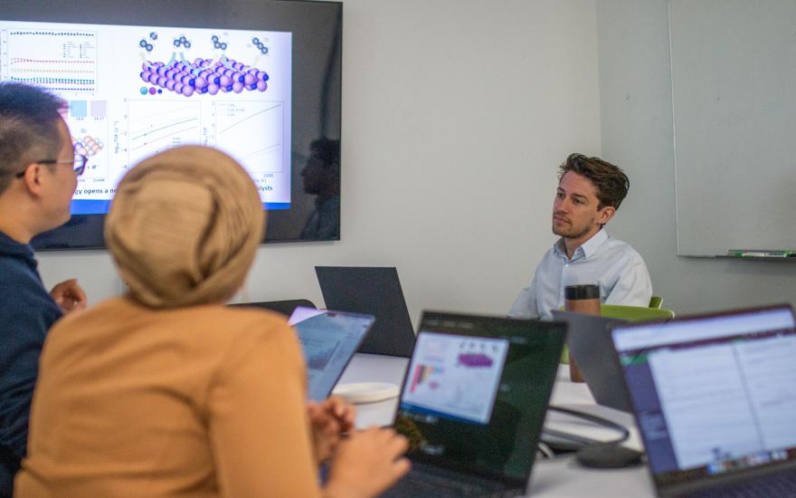 Image of BIDMaP's postdoctoral researchers sitting at a table while meeting