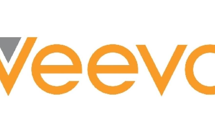 Logo of Veeva in bright orange with grey triangle nested inside first "V"